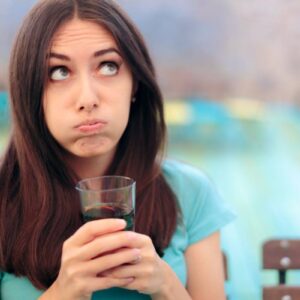 Women wondering if she should drink a soda