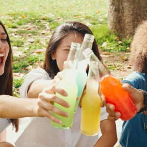 friends drinking soda in a park