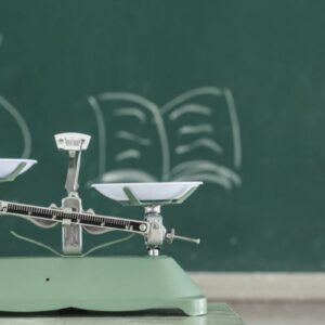 weight loss scale showing money and education on a black board